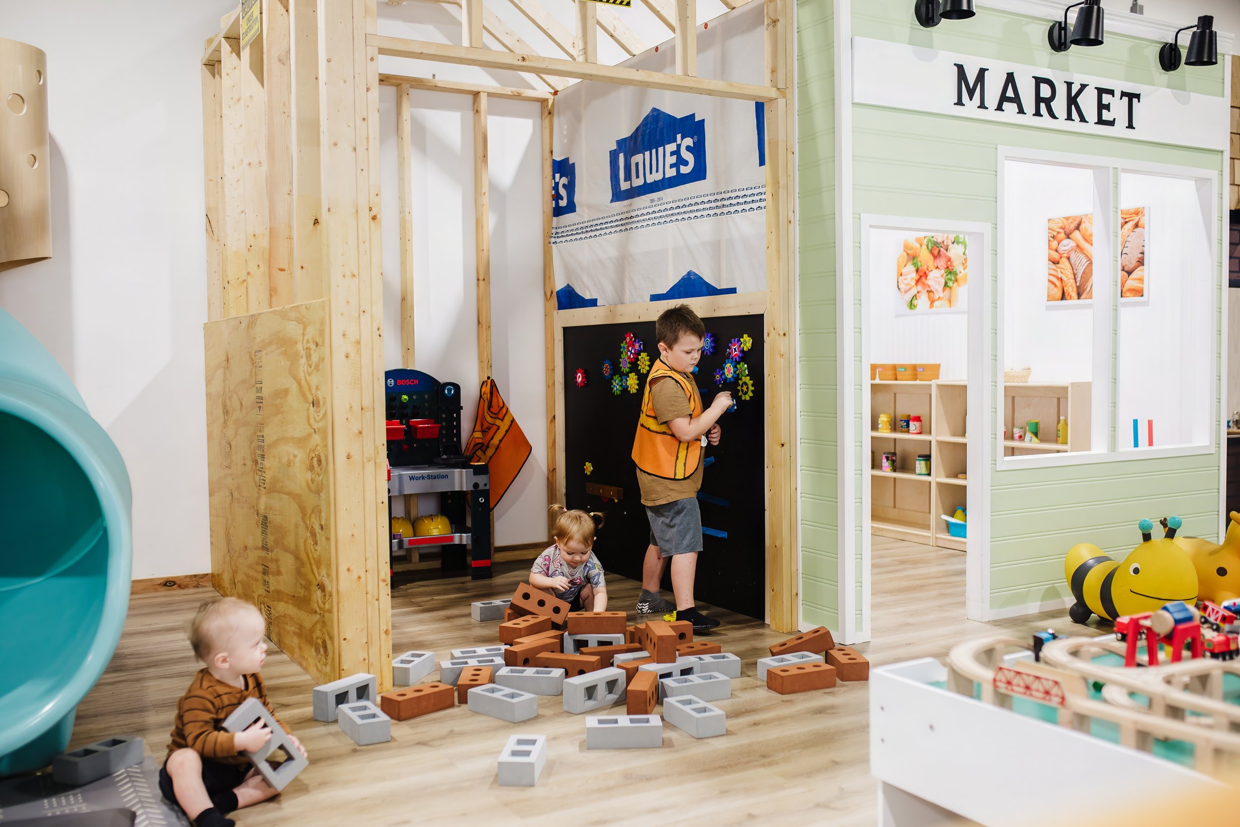 Children building and playing in the Little Peaches market area.