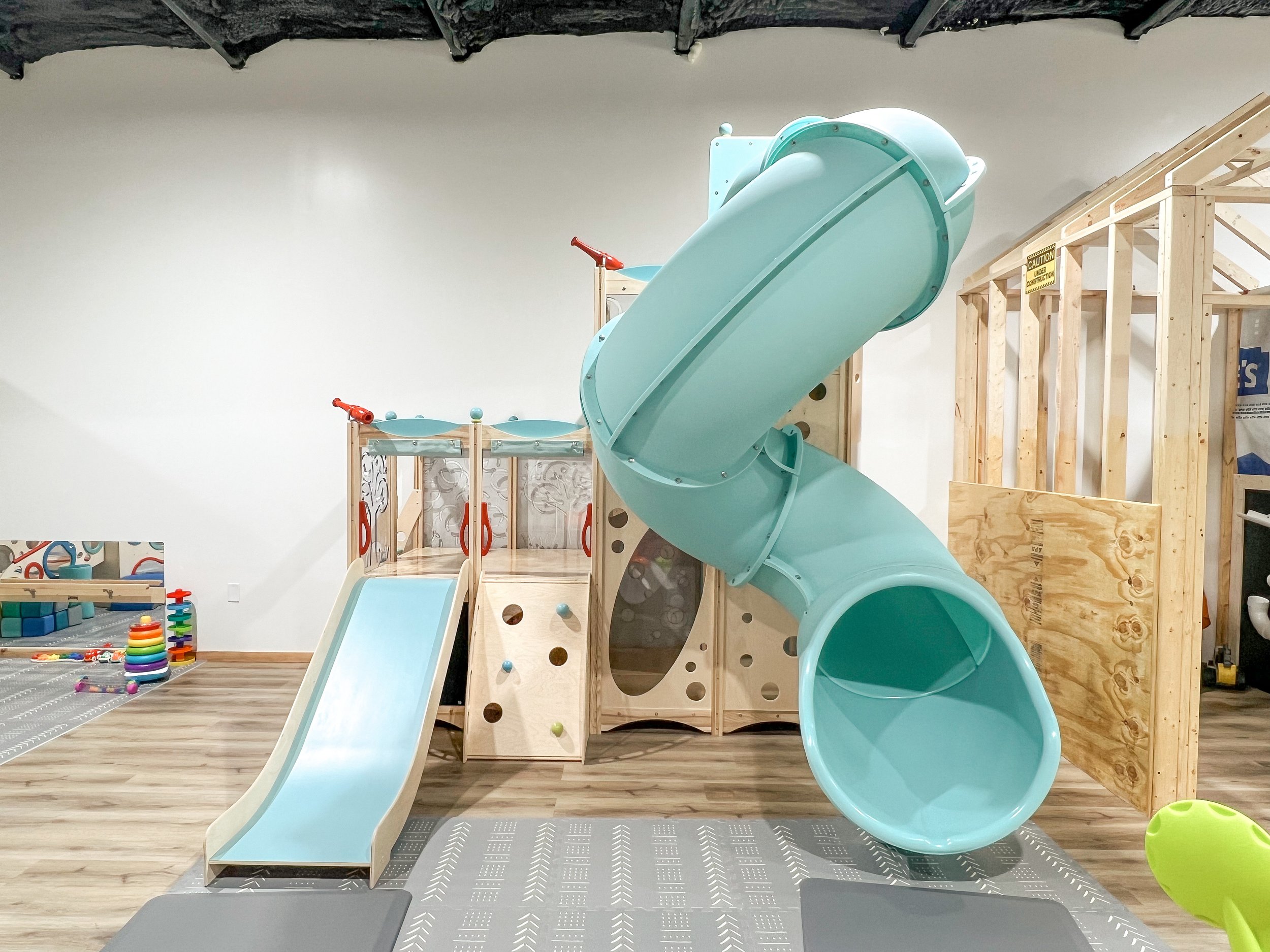 Indoor play area with imaginative play structures.